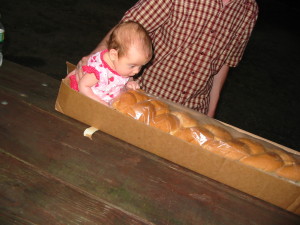 A well-supported baby Bridget is duly impressed by generous food donations, even though she couldn't eat it yet.