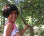 Child holding a tree in the Middlesex Fells Reservation