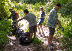 Tufts University students collecting discarded cans from the trailside to be recycled 